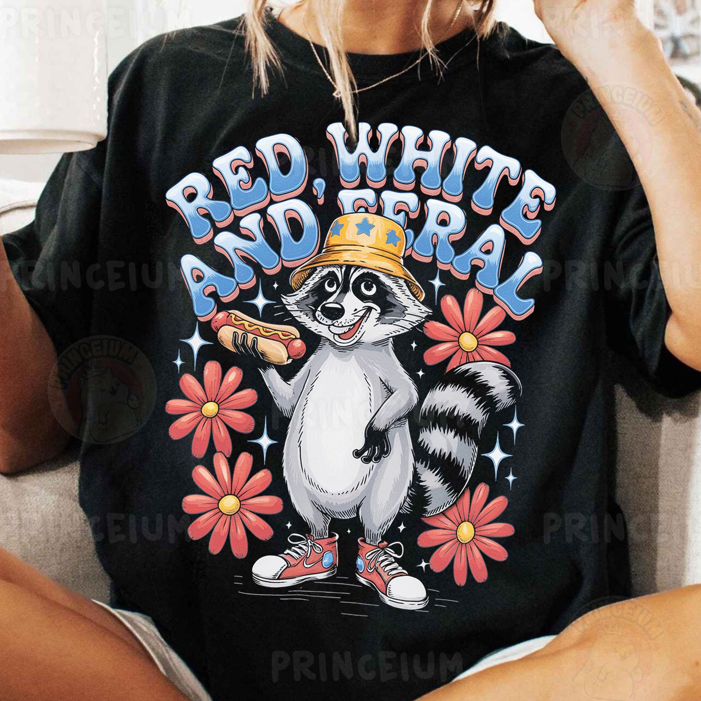 a woman sitting on a couch wearing a raccoon t - shirt