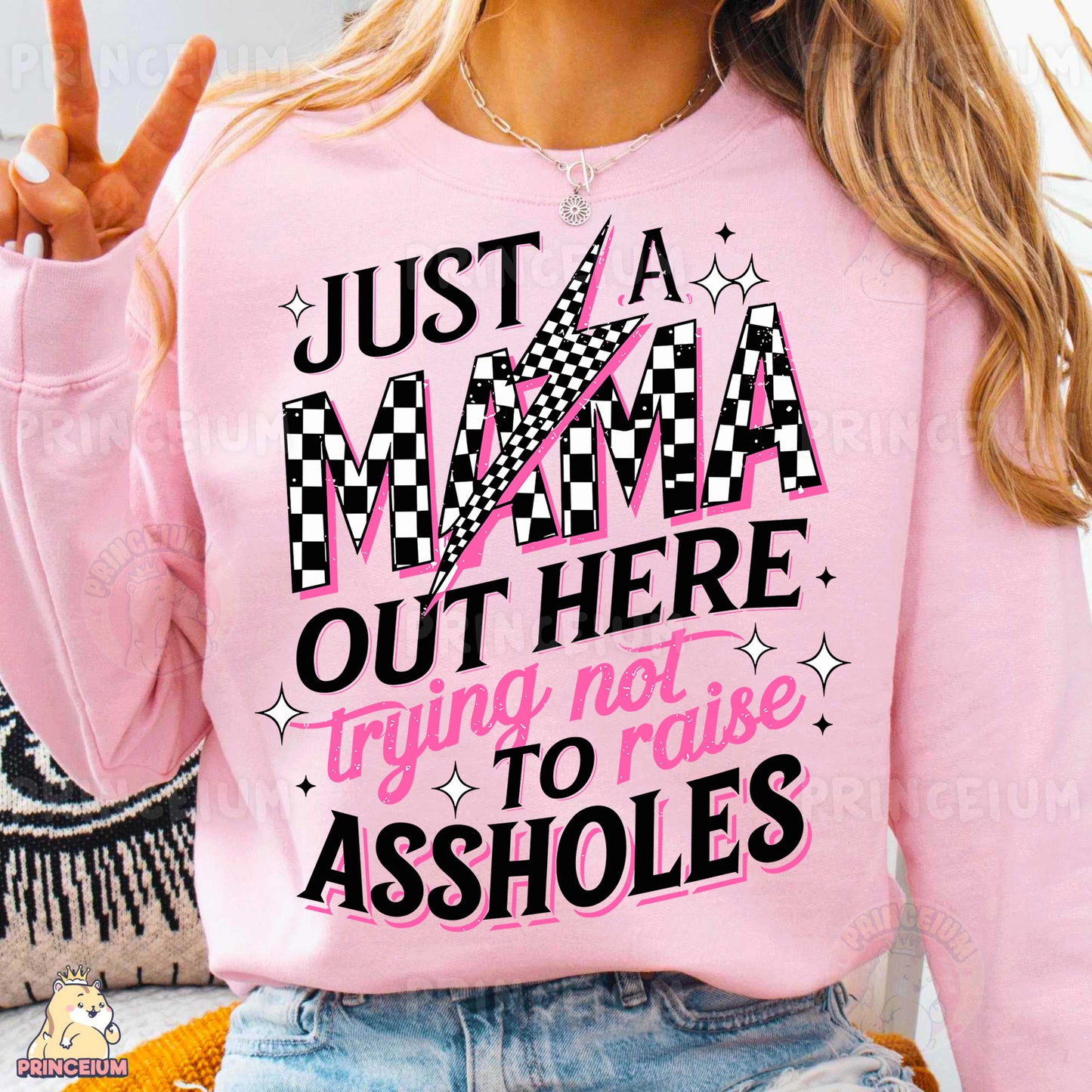 a woman wearing a pink shirt that says just a mama out here trying not to