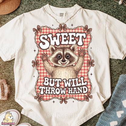 a t - shirt with a raccoon saying sweet but will throw hand