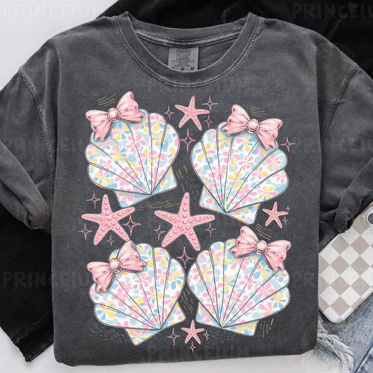 a black shirt with pink bows and seashells on it