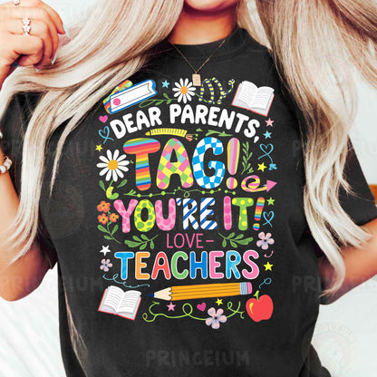a woman wearing a t - shirt that says dear parents tag you're it