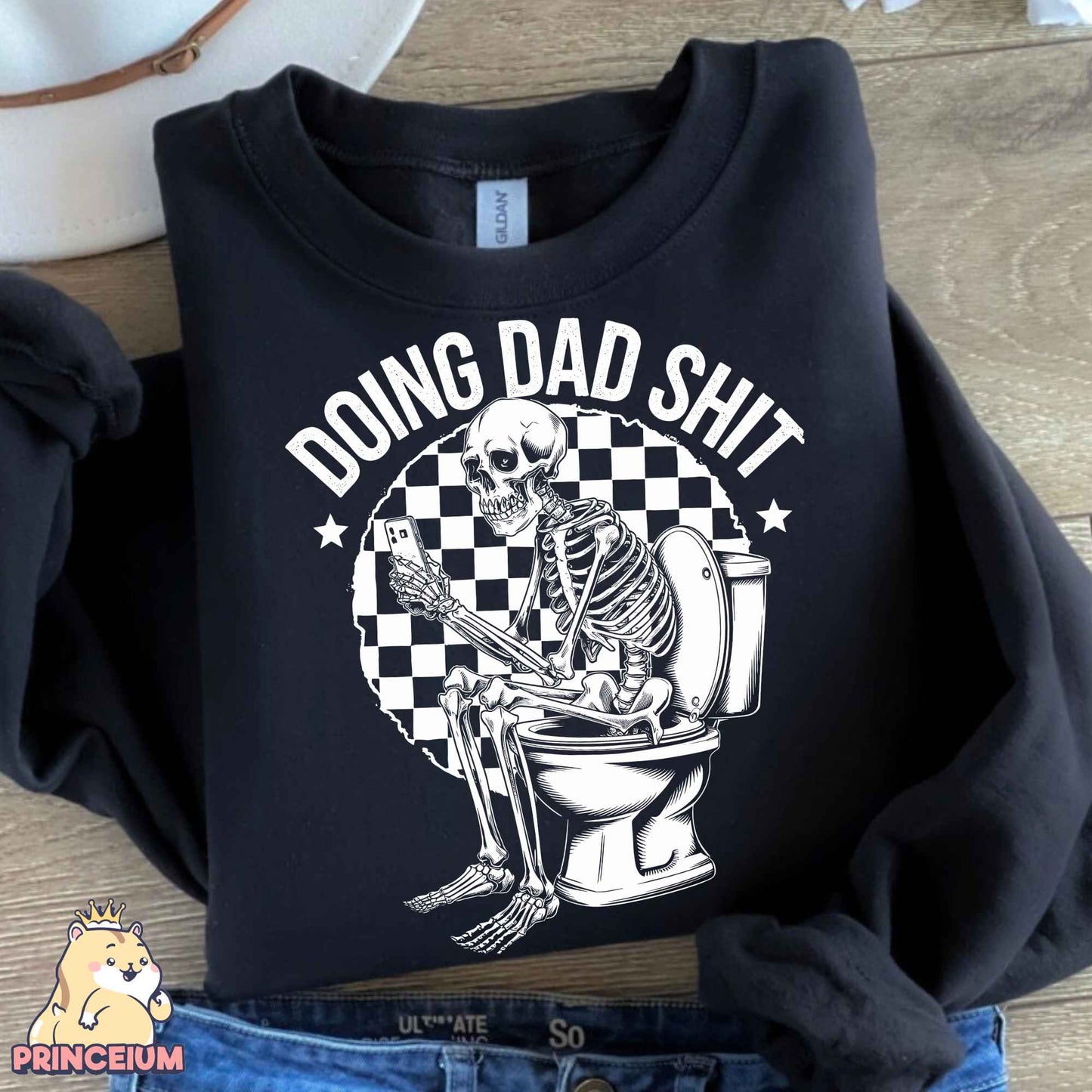 a black shirt with a skeleton sitting on a toilet