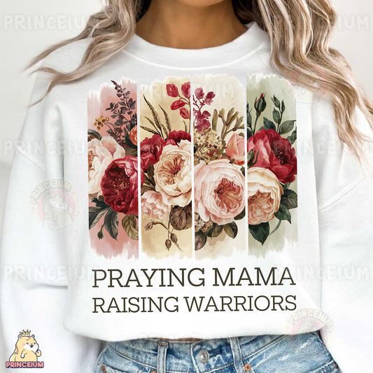 a woman wearing a white shirt that says praying mama raising warriors