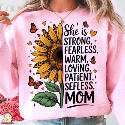 a woman wearing a pink sweatshirt with a sunflower and butterflies on it