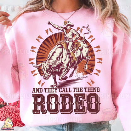 a woman wearing a pink shirt that says rodeo and they call the thing rodeo