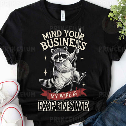 a raccoon t - shirt that says mind your business my wife is expensive