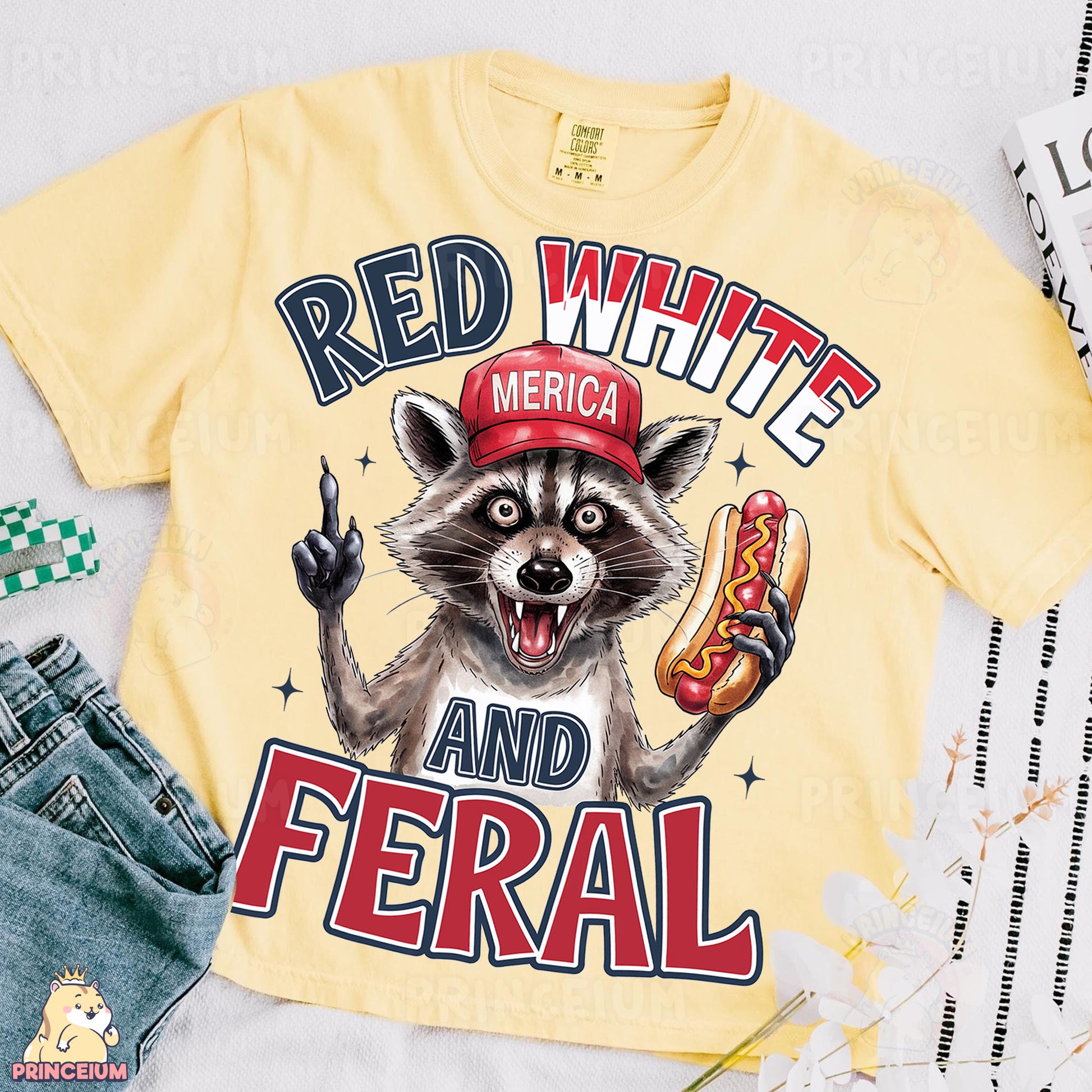 a yellow shirt with a raccoon wearing a red hat and holding a hot
