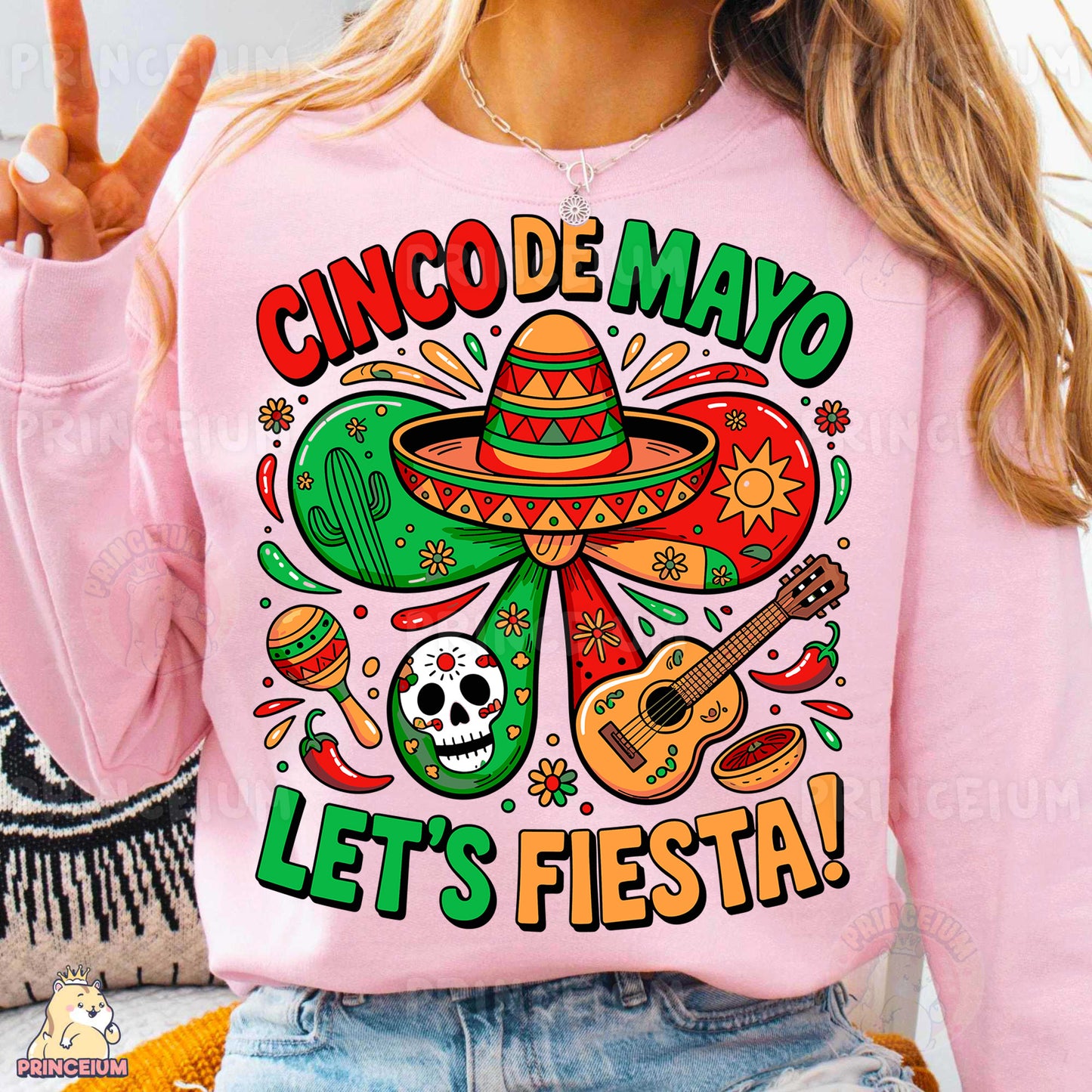 a woman wearing a pink shirt with a mexican design on it