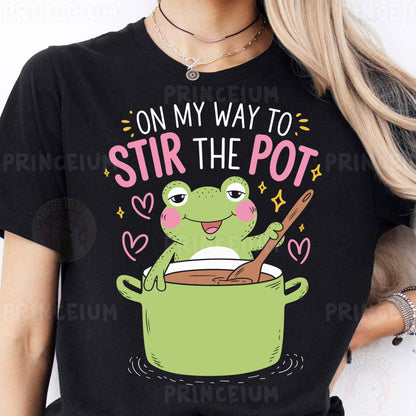 a woman wearing a black t - shirt that says on my way to stir the