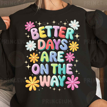 a woman wearing a black sweatshirt that says better days are on the way