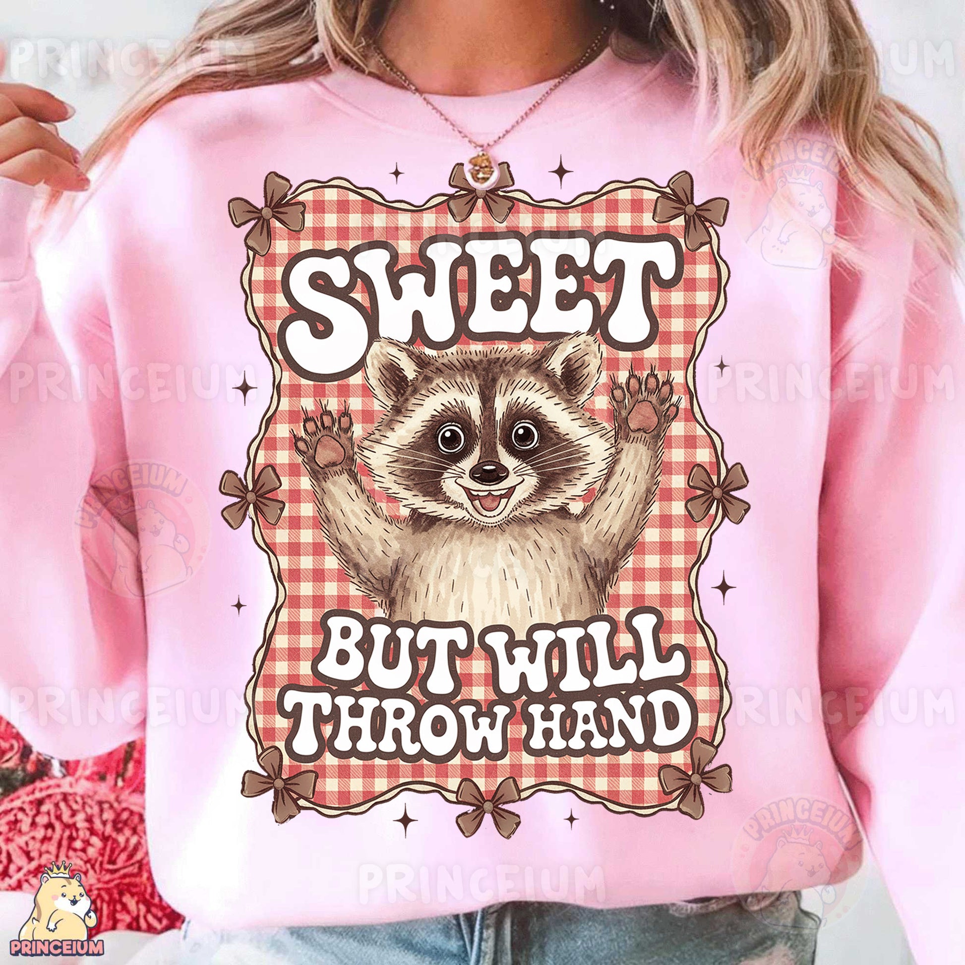 a woman wearing a pink sweatshirt with a raccoon on it