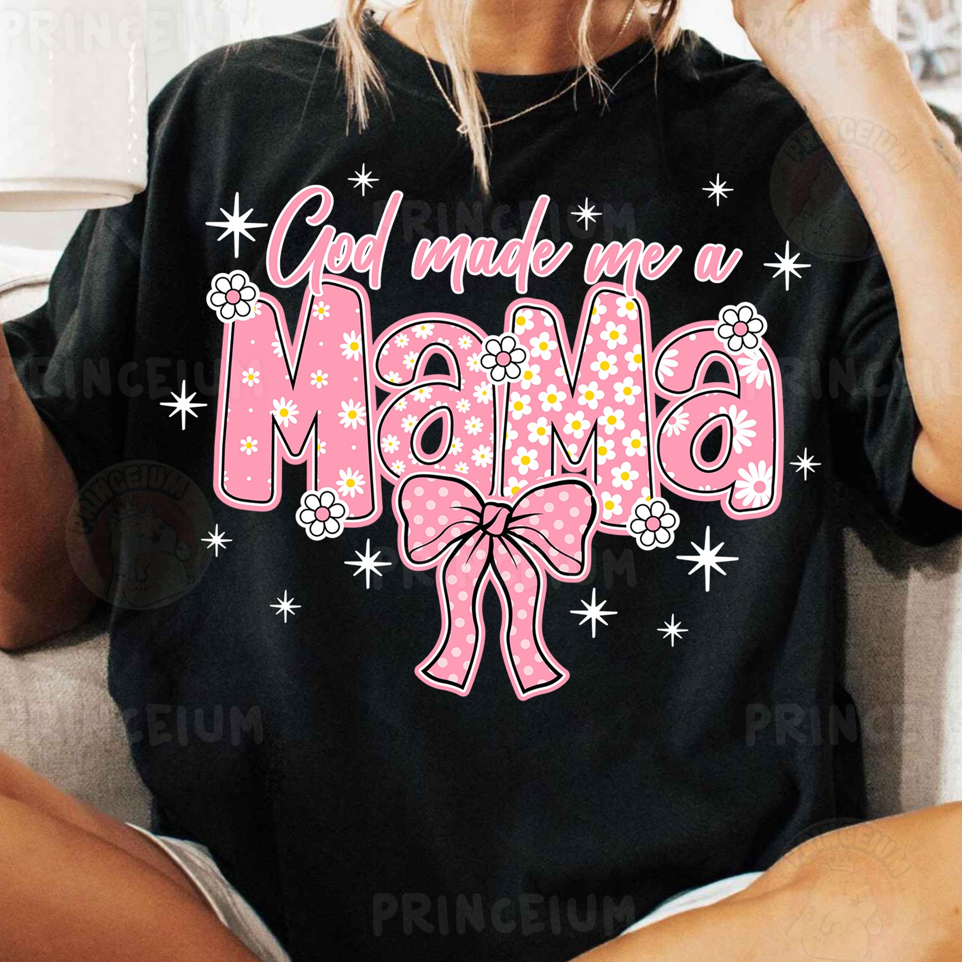 a woman sitting on a couch wearing a shirt that says god made me a mama