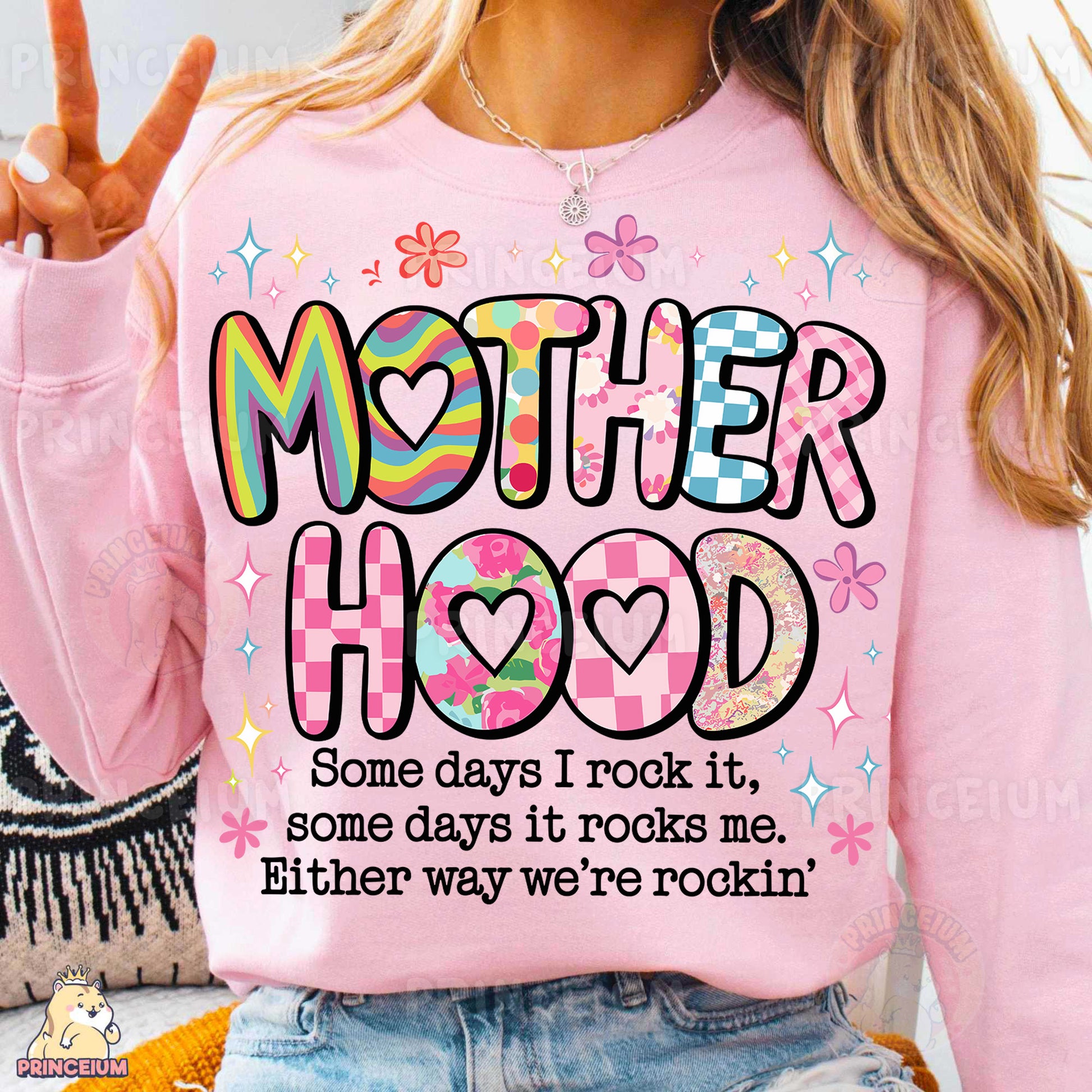 a woman wearing a pink shirt that says motherhood