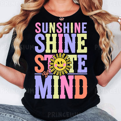 a woman wearing a black shirt that says sunshine shine smile mind