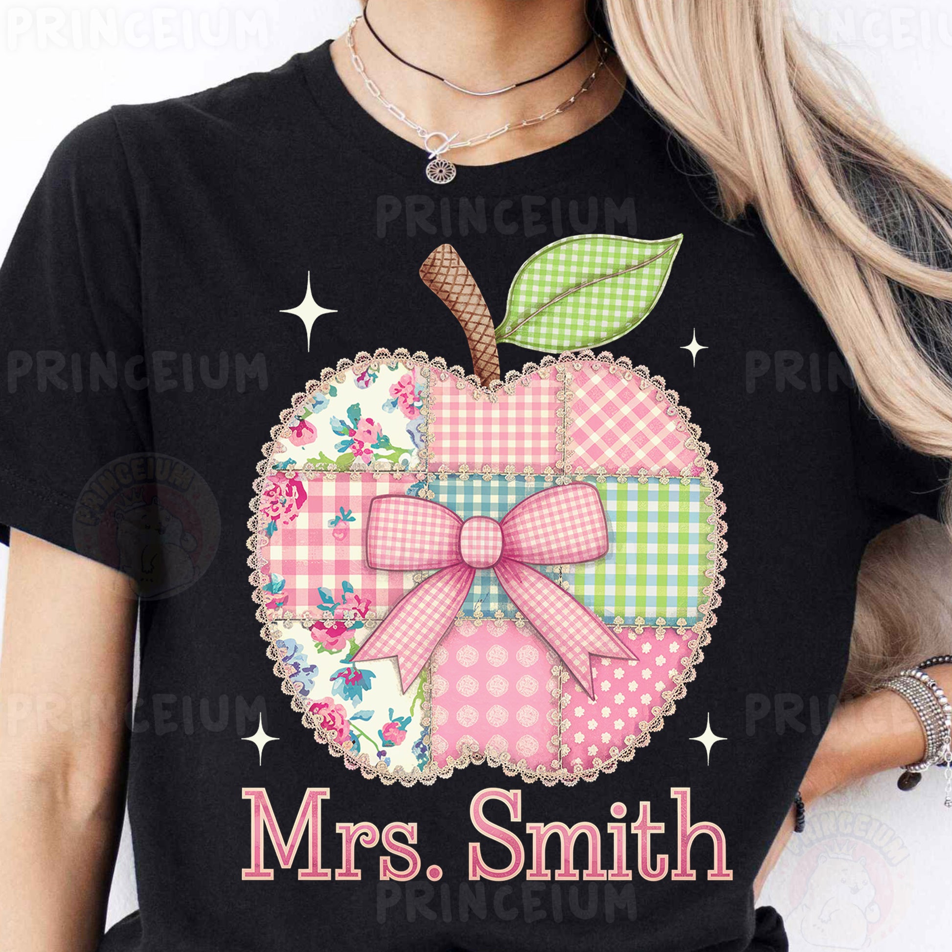 a woman wearing a black shirt with a pink apple on it