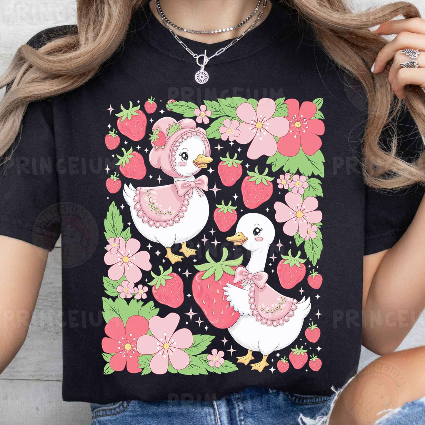 a woman wearing a black t - shirt with a picture of two ducks on it