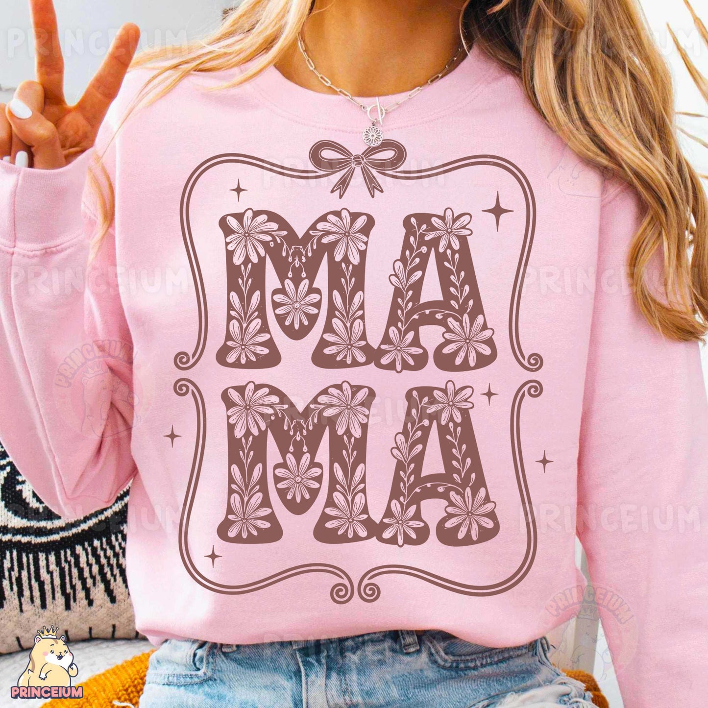 a woman wearing a pink shirt with the word mam on it