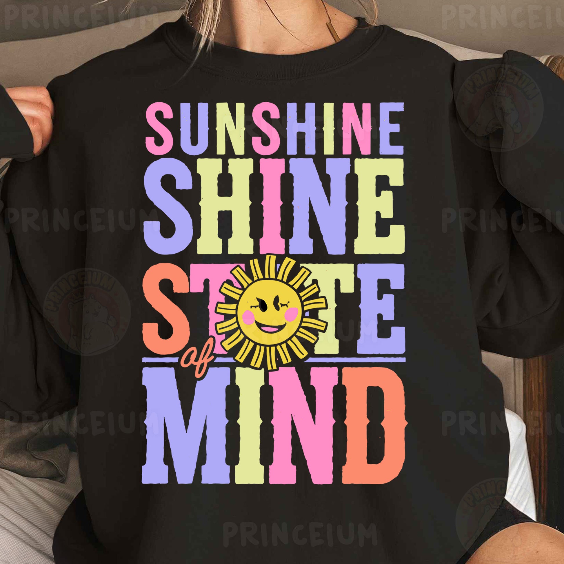 a woman wearing a black sweatshirt with the words sunshine shine and a smiling sun on