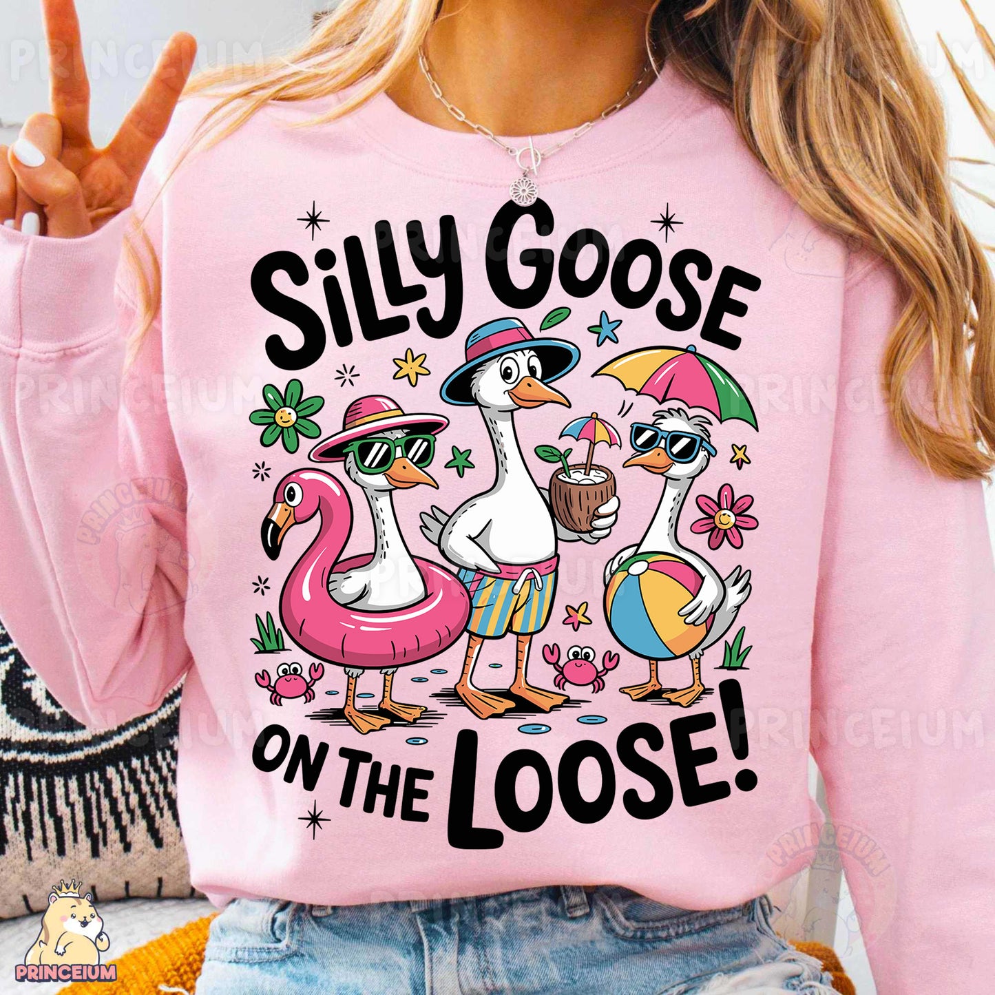 a woman wearing a pink shirt with a flamingo and two ducks on it