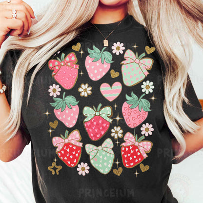 a woman with blonde hair wearing a black shirt with strawberries on it