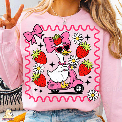 a woman wearing a pink shirt with a duck riding a scooter