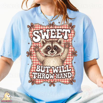a woman wearing a blue shirt with a raccoon on it