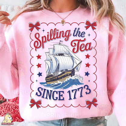 a woman wearing a pink shirt with a ship on it