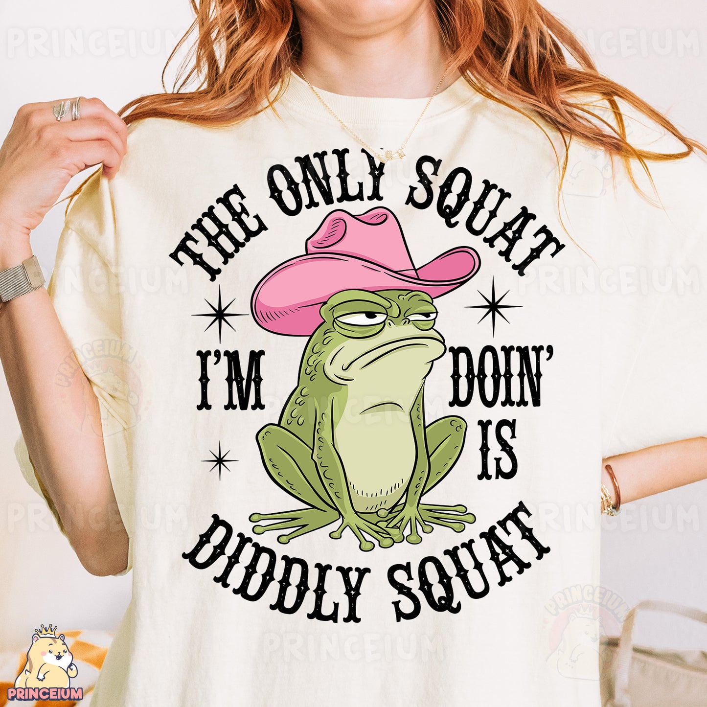 a woman wearing a t - shirt with a frog wearing a pink cowboy hat