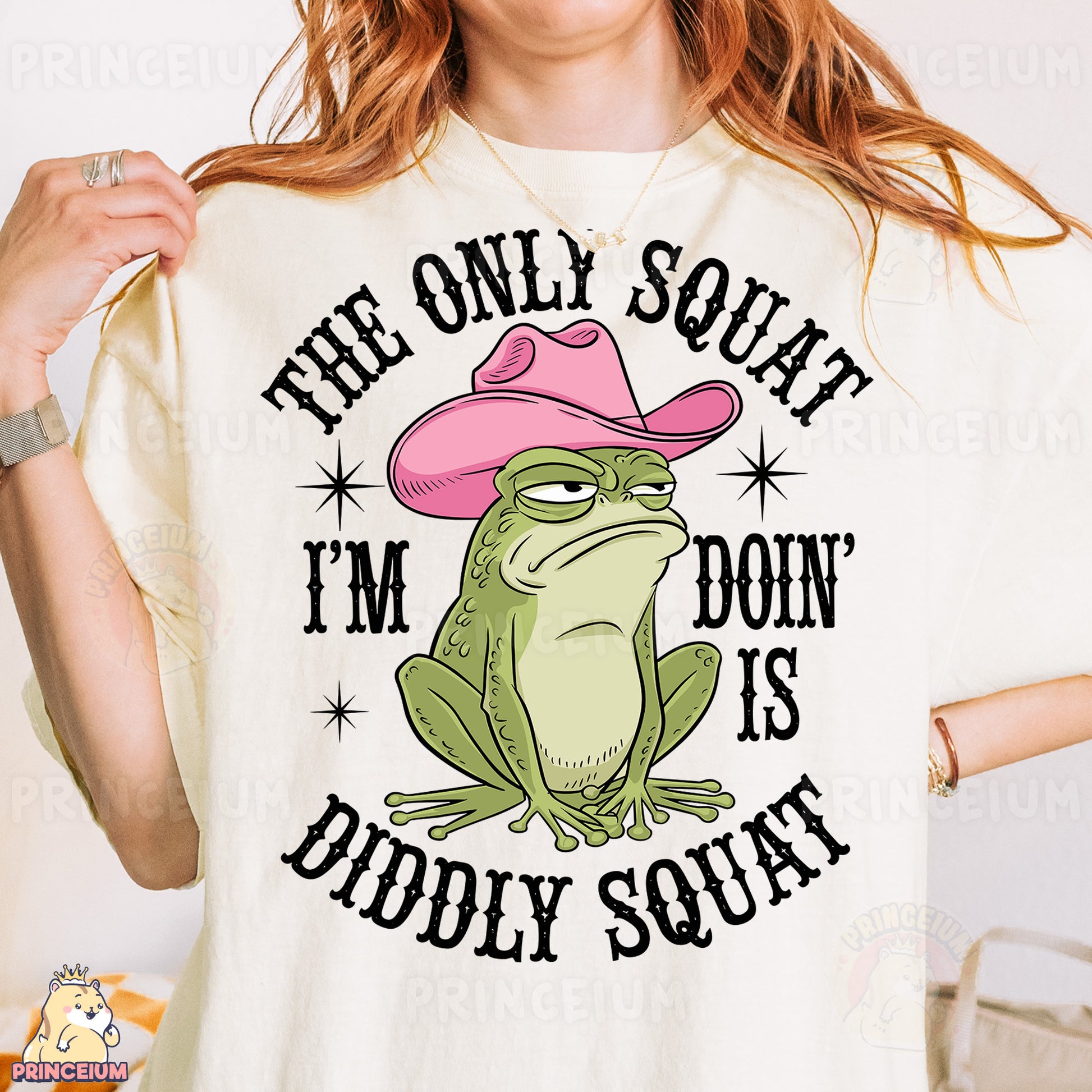 a woman wearing a t - shirt with a frog wearing a pink cowboy hat