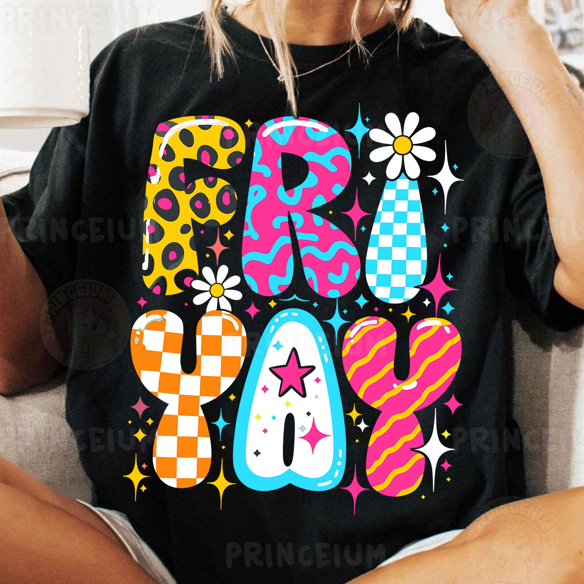 a woman sitting on a couch wearing a black shirt with colorful letters