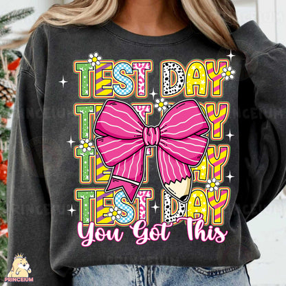 a woman wearing a black shirt with a pink bow on it