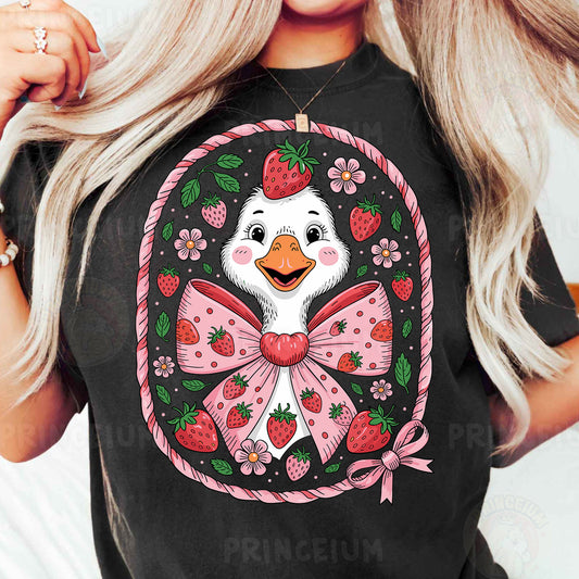 a woman wearing a t - shirt with a duck wearing a bow and strawberries