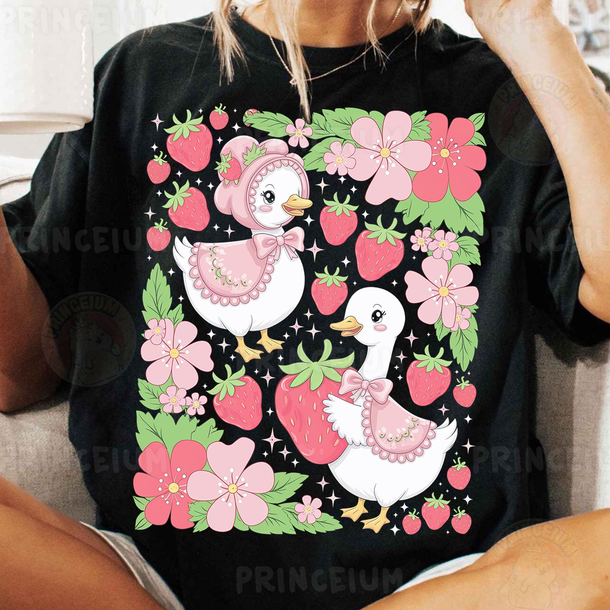 a woman sitting on a couch wearing a black shirt with pink flowers and two ducks