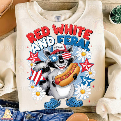a white shirt with a raccoon eating a hot dog