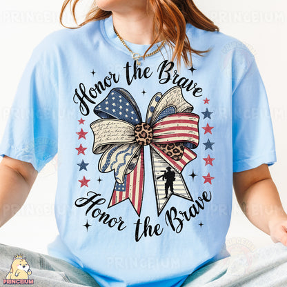 a woman wearing a blue t - shirt with an american flag bow