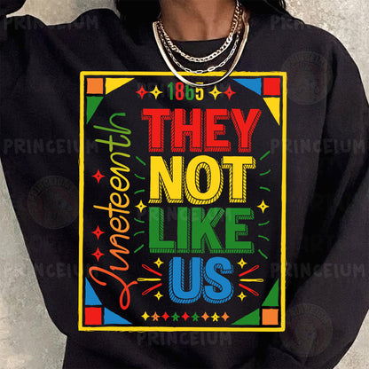 a woman wearing a black sweatshirt with the words they not like us printed on it
