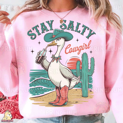 a woman wearing a pink sweatshirt with a duck on it