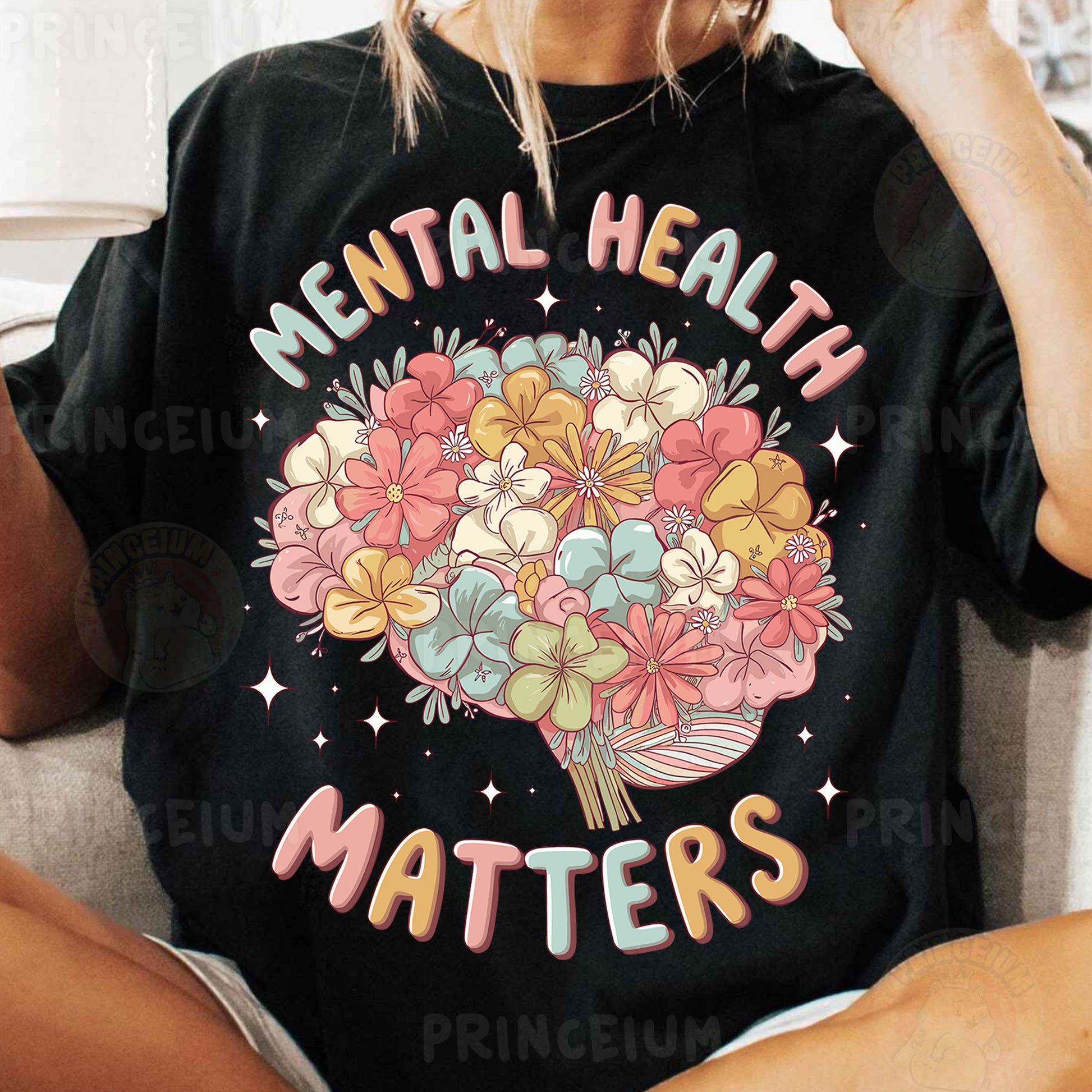 a woman sitting on a couch wearing a t - shirt that says mental health matters