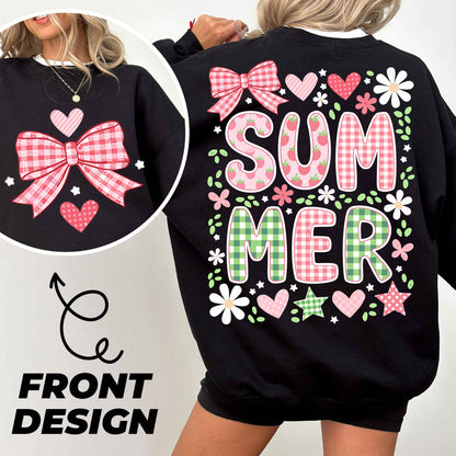 a woman wearing a black sweatshirt with pink and green bows