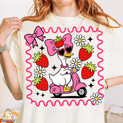 a woman wearing a t - shirt with a dog riding a scooter