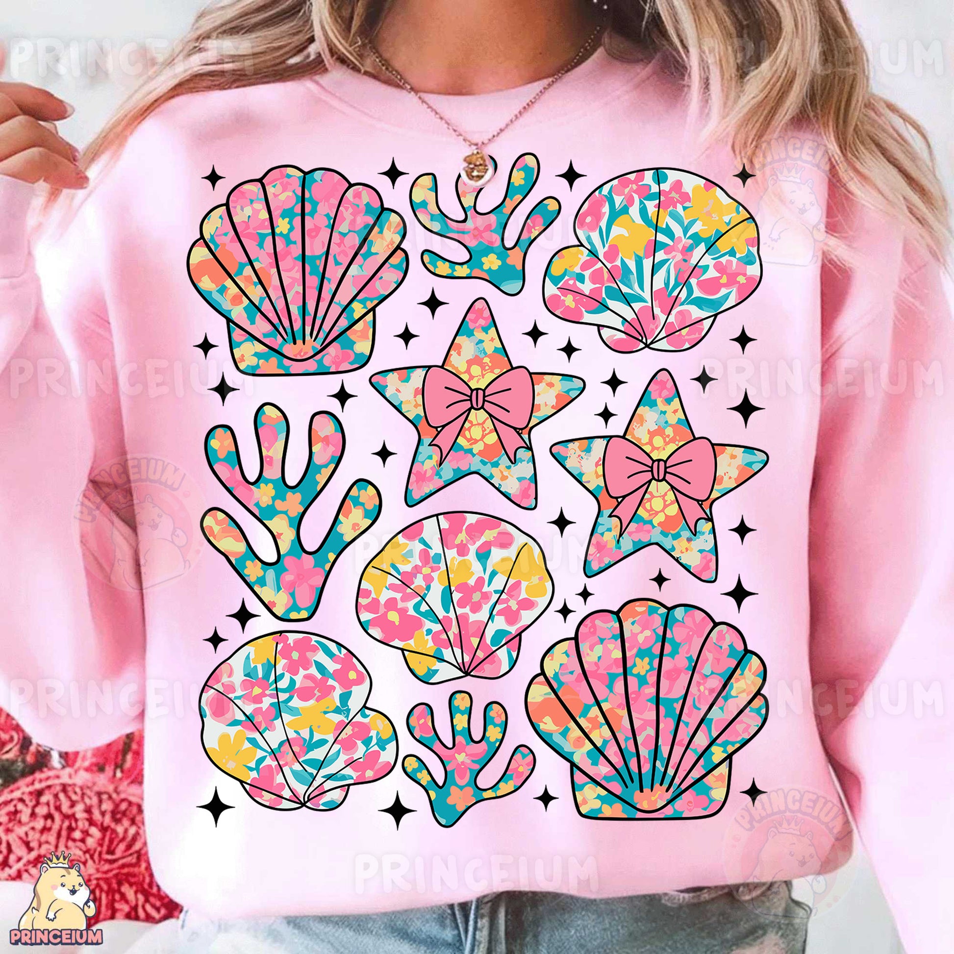 a woman wearing a pink sweatshirt with colorful seashells on it