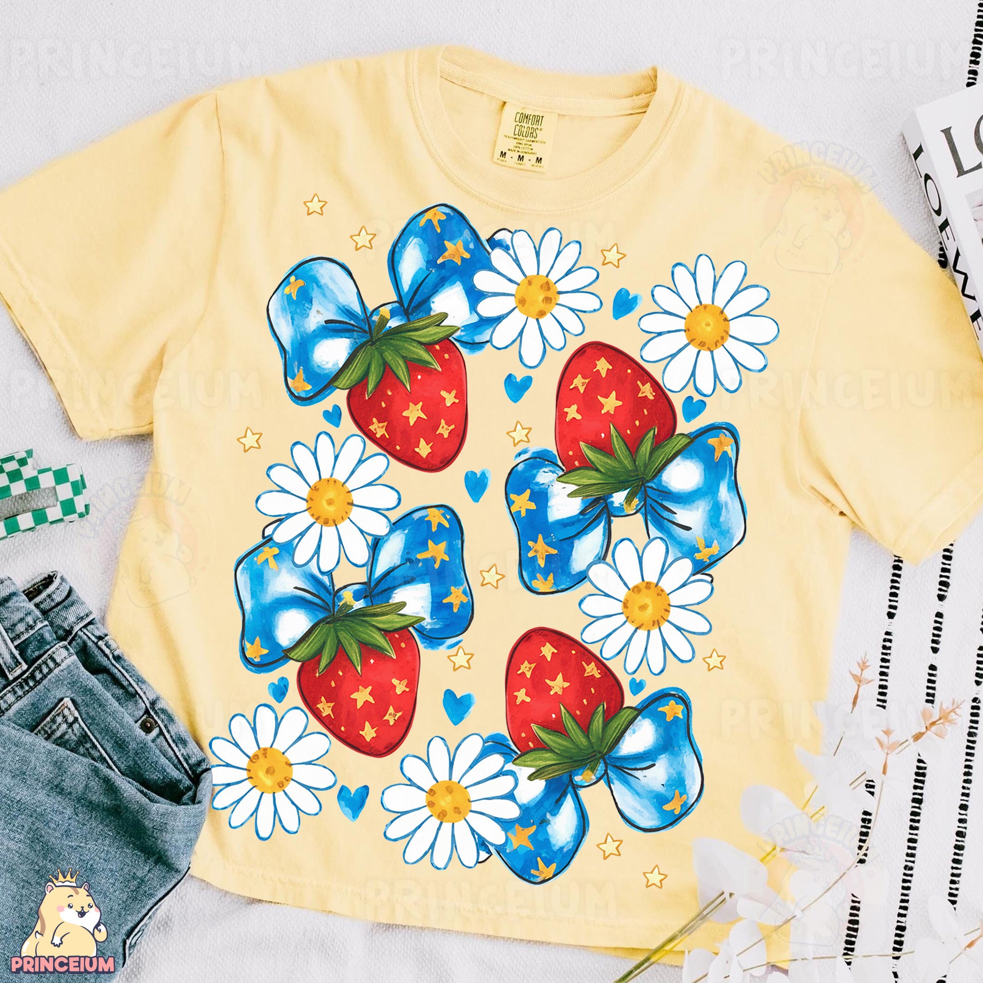 a yellow shirt with a blue bow and a strawberry on it