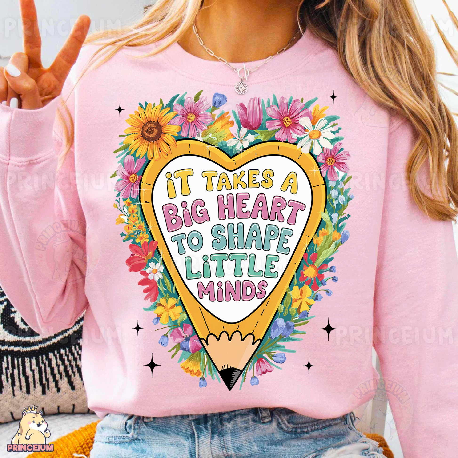 a woman wearing a pink sweatshirt with a heart and flowers on it