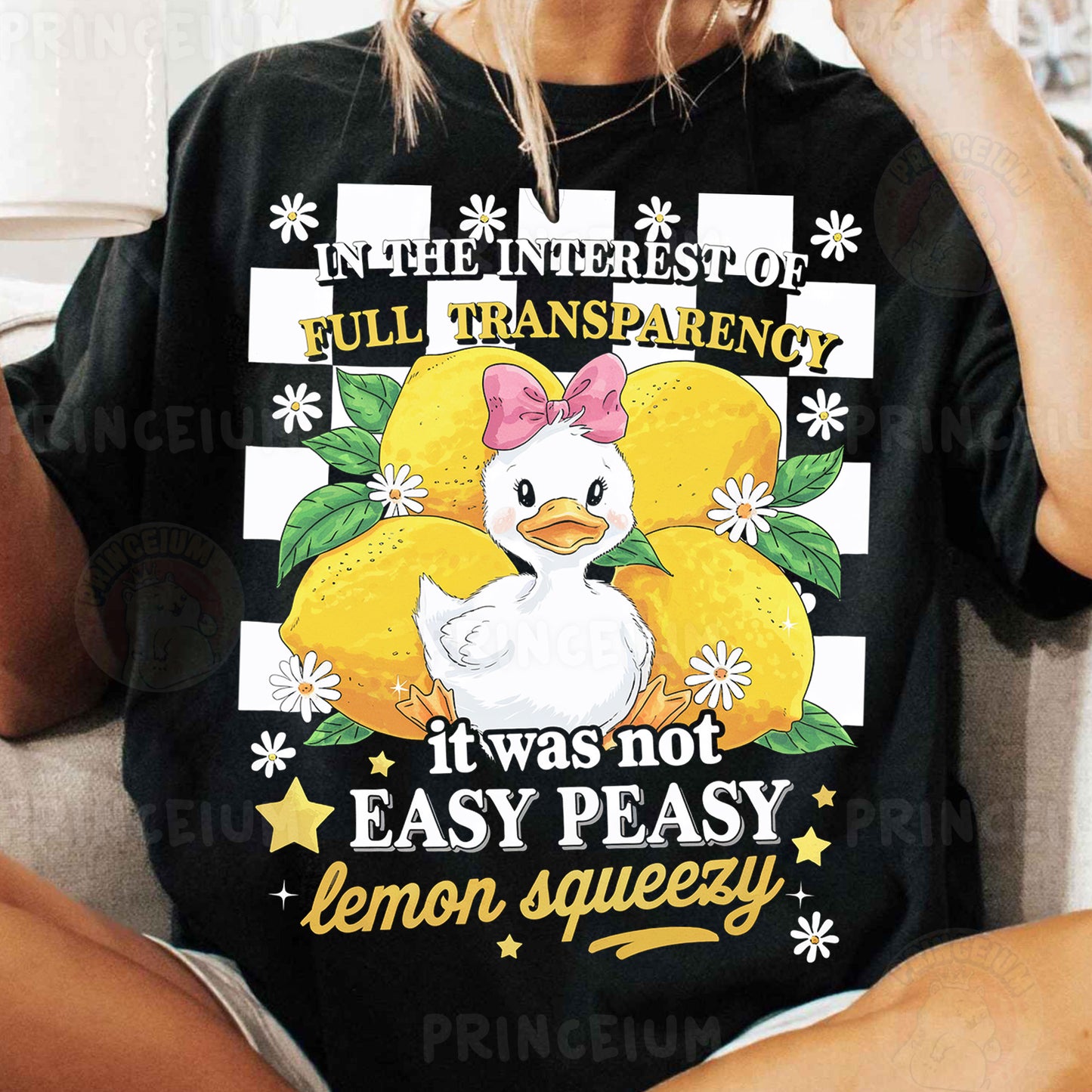 a woman sitting on a couch wearing a black shirt