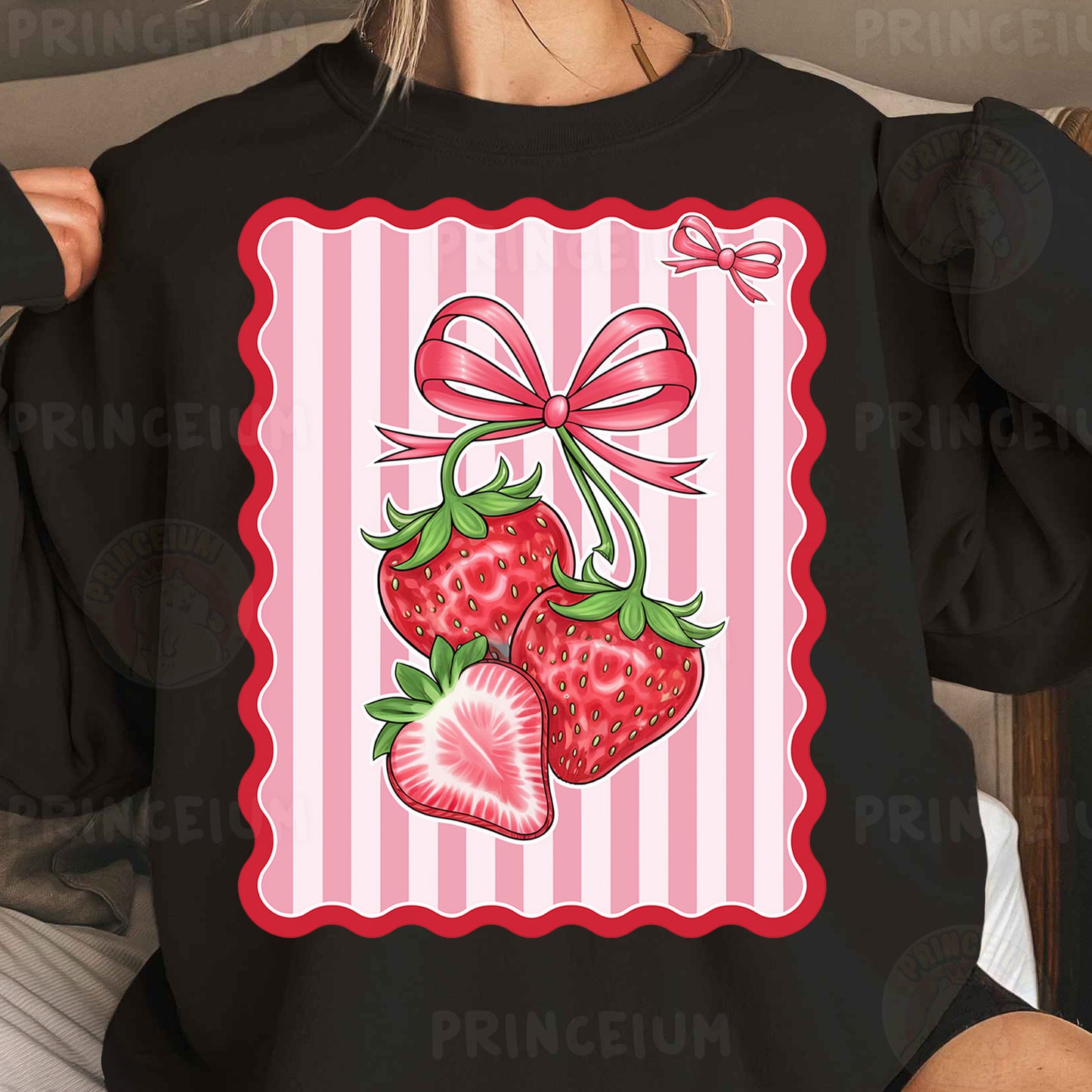 a woman wearing a black shirt with a pink bow and two strawberries on it