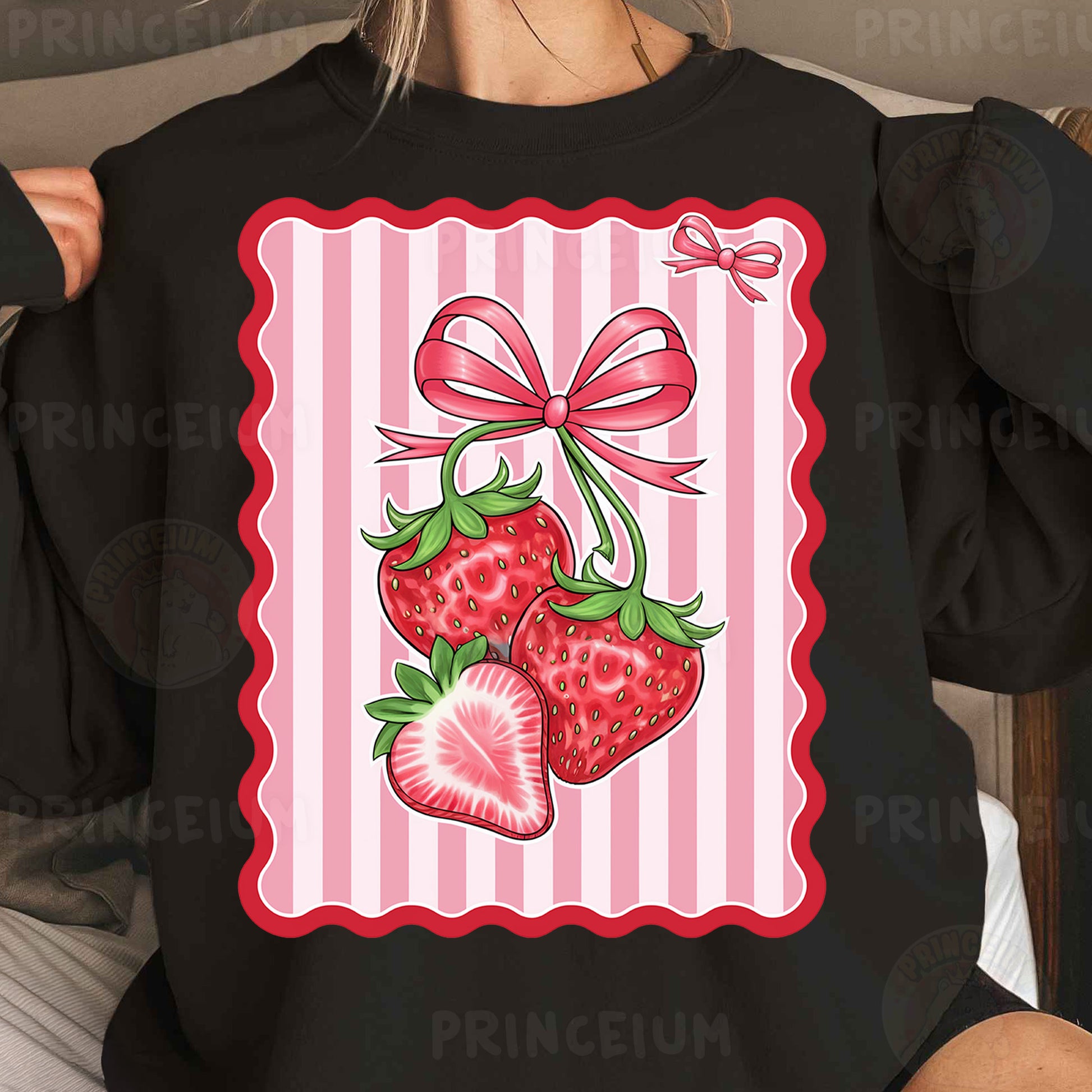 a woman wearing a black shirt with a pink bow and two strawberries on it