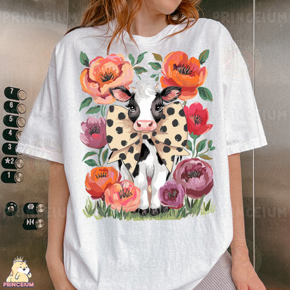a woman wearing a white shirt with a cow and flowers on it