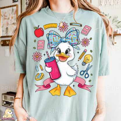 a woman wearing a t - shirt with an image of a duck holding a drink