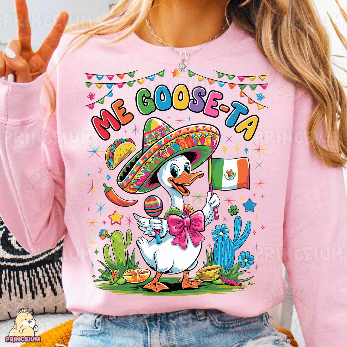 a woman wearing a pink sweatshirt with a mexican duck wearing a sombrero