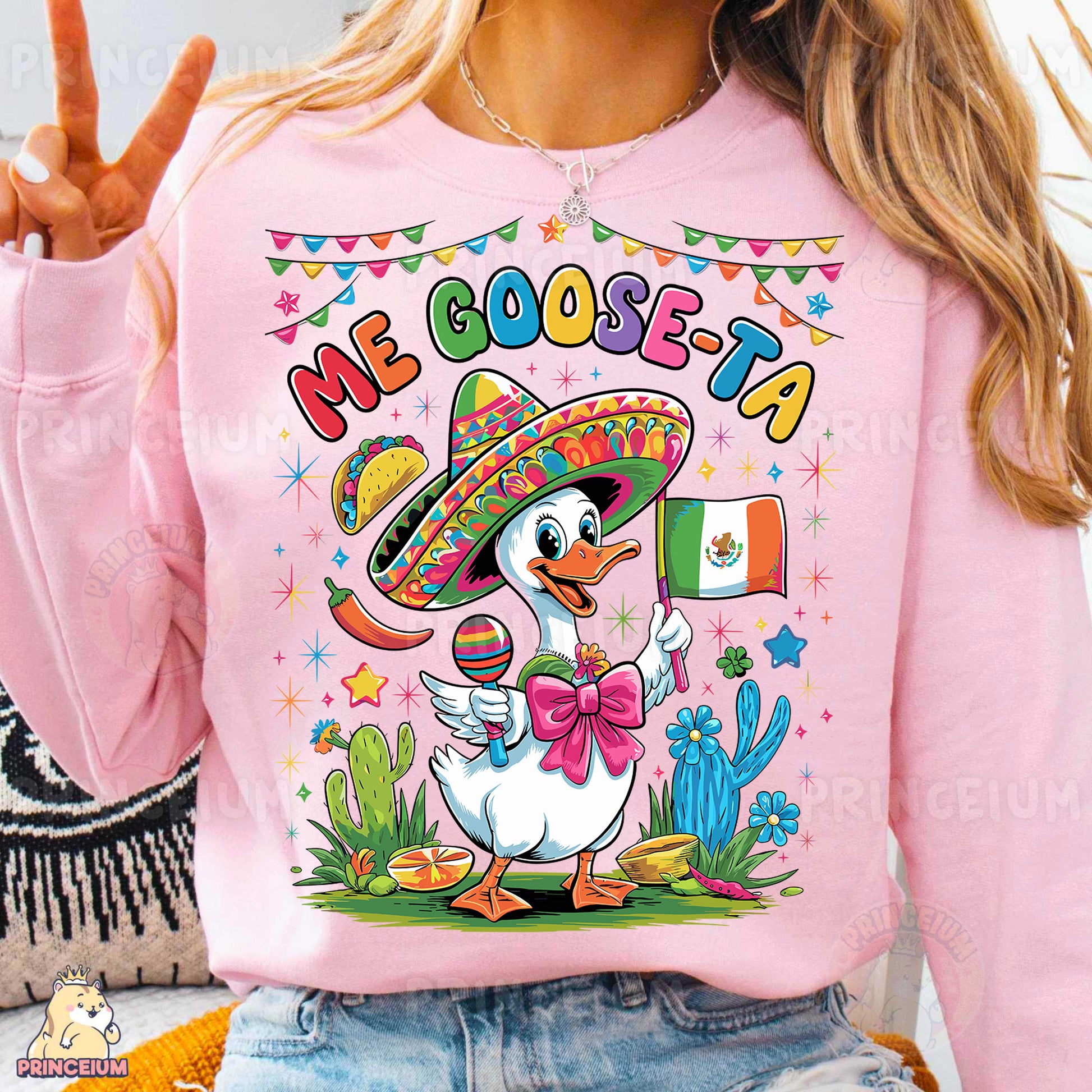 a woman wearing a pink sweatshirt with a mexican duck wearing a sombrero